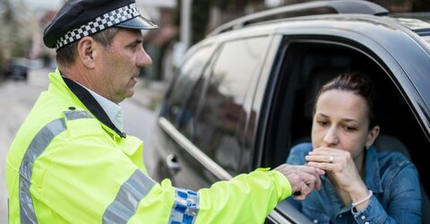 A driver taking a breath test at the roadside